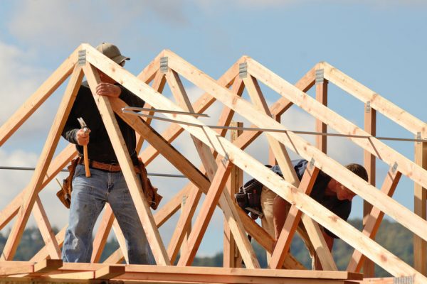 Layout and installation of roof rafters on a new commercial residential construciton project by framing contactors